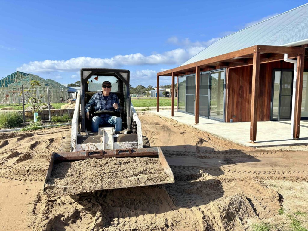 Community Shed Handovers - Stage Four 3 4a community garden lawn Mike on digger